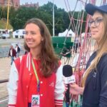 zdjęcie przedstawiające młodą kobietę udzielającą wywiadu na statku, młodej dziennikarce