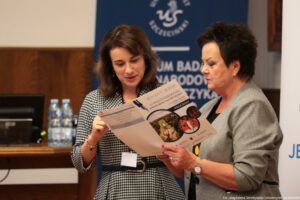 Ujęcie bokiem. Dwie uczestniczki III Międzynarodowego Kongresu Języka i Kultury Polskiej trzymają i czytają program wydarzenia.