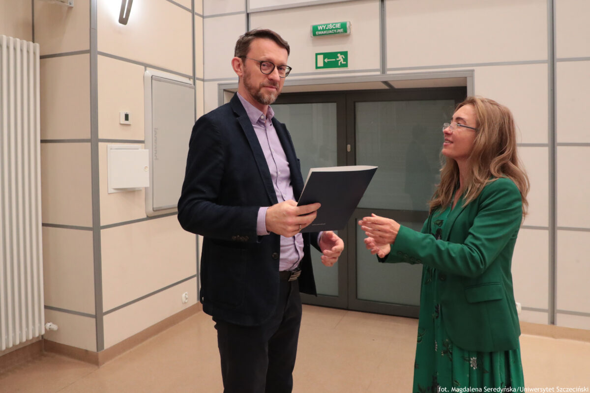 Perły Instytutu Ekonomii i Finansów 2025. Po lewej wyróżniony naukowiec odbierający teczkę, po prawej dyrektorka Instytutu.