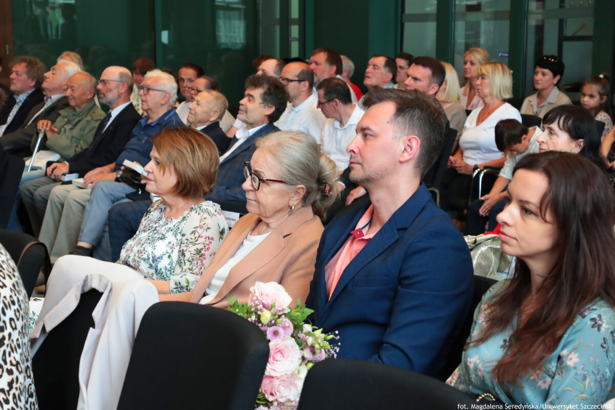 Goście uroczystości wręczenia Medalu za Zasługi dla Miasta Szczecina siedzący w rzędach ustawionych jeden z drugim.